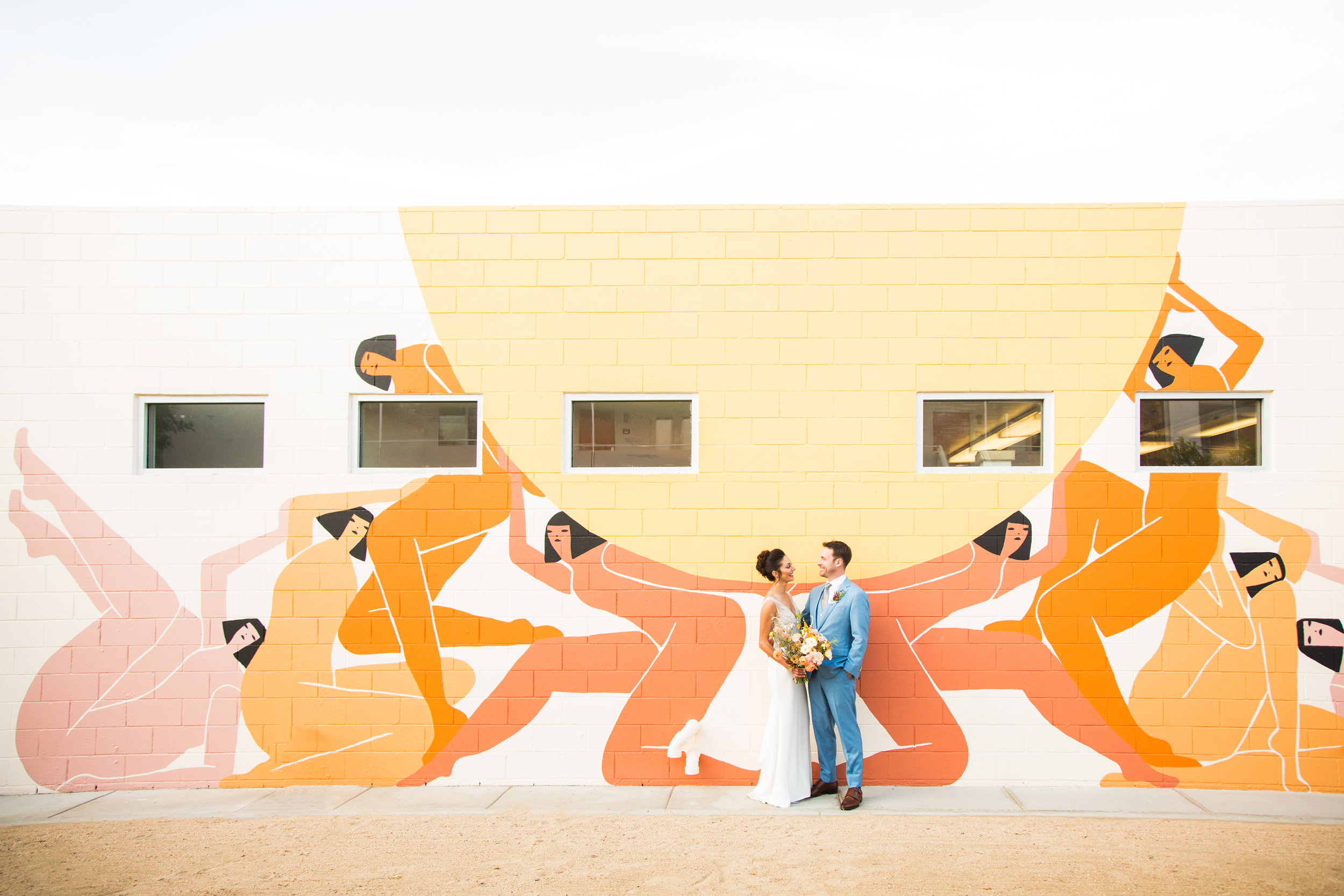 Bride and Groom in front of Laura Berger mural in Palm Springs