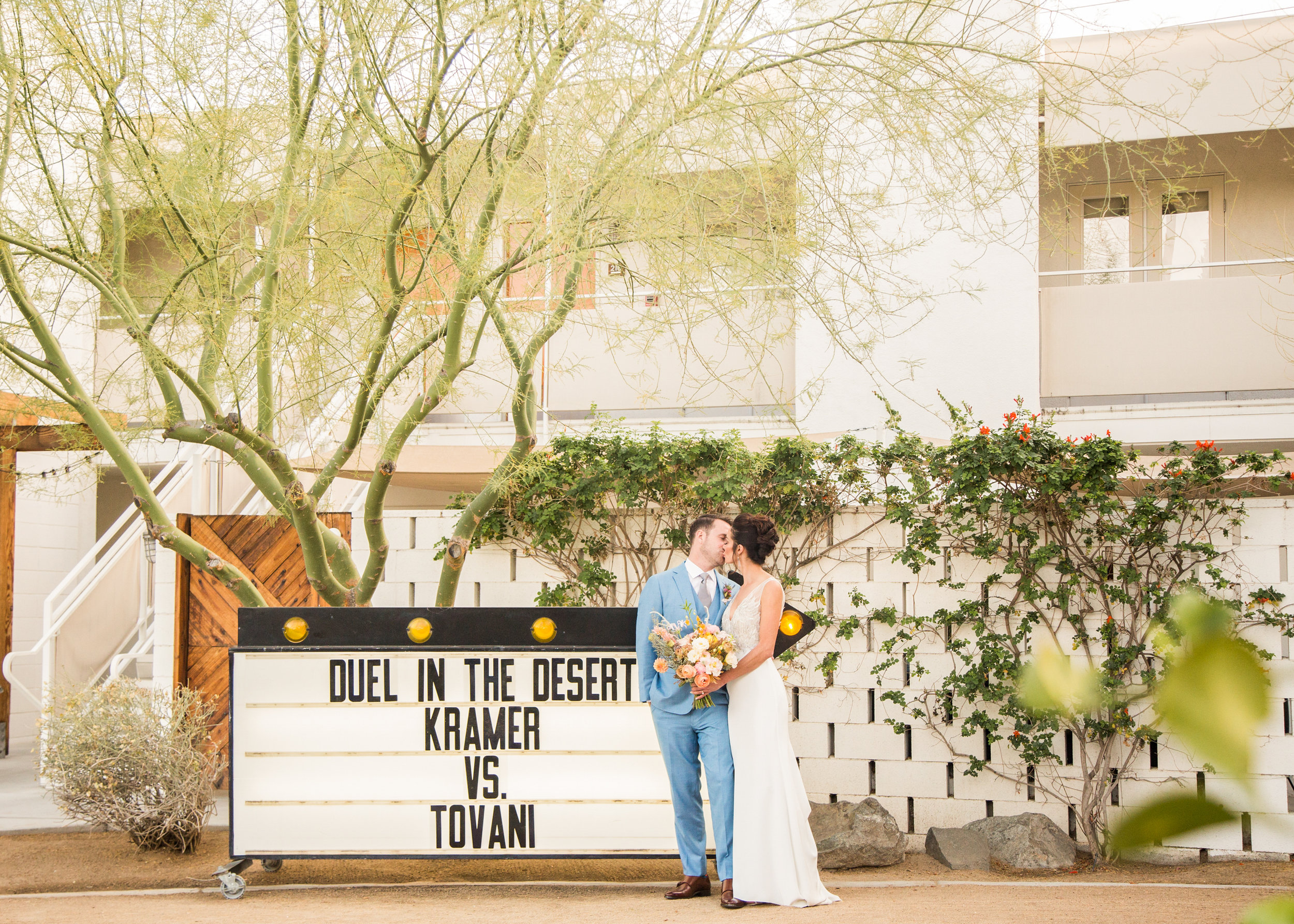Couple kissing in front of Marquee and Ace Hotel and Swim Palm Springs