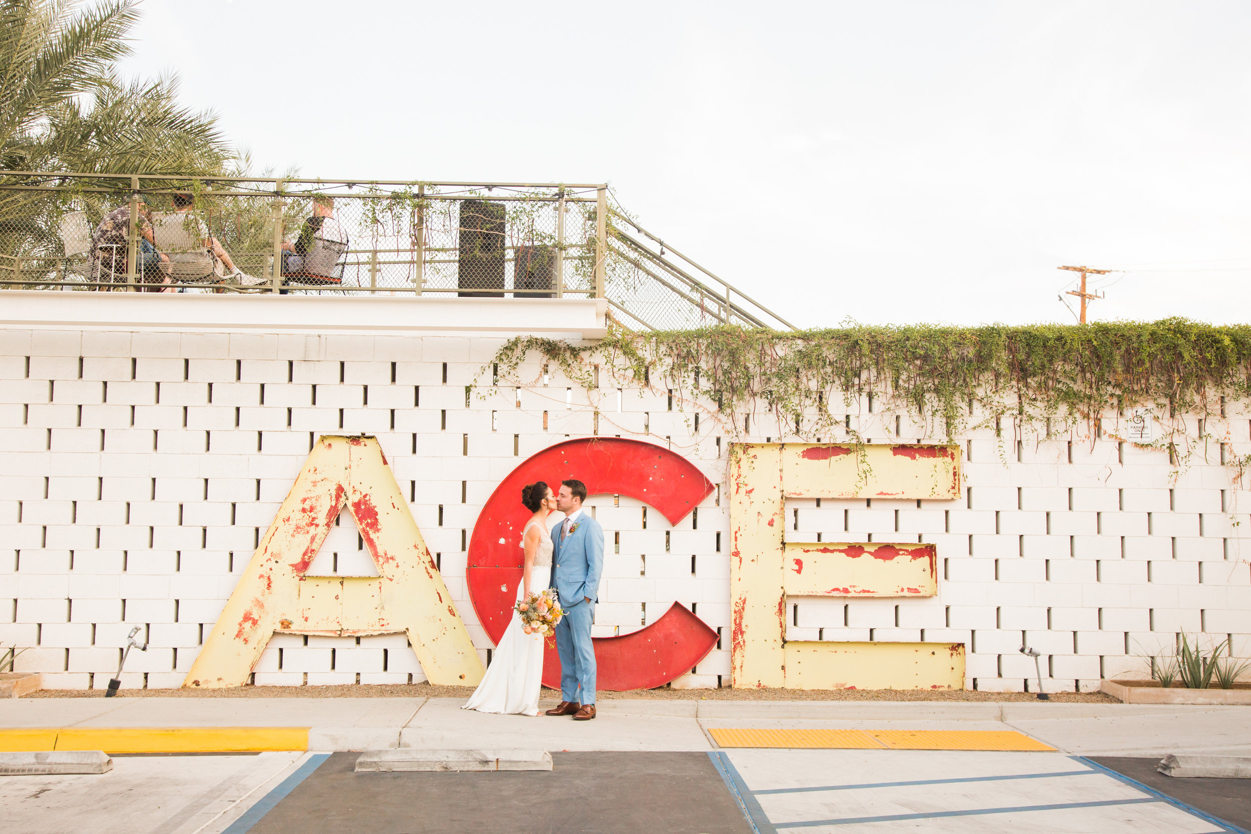 Couple kissing in front of Ace Hotel Palm Springs