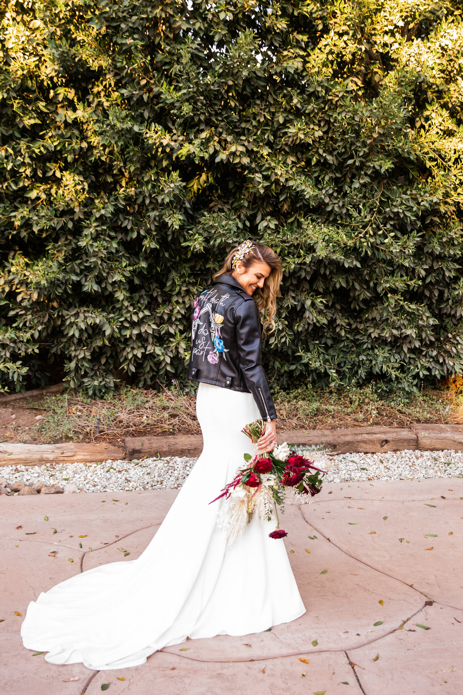Edgy boho bride with custom painted leather jacket